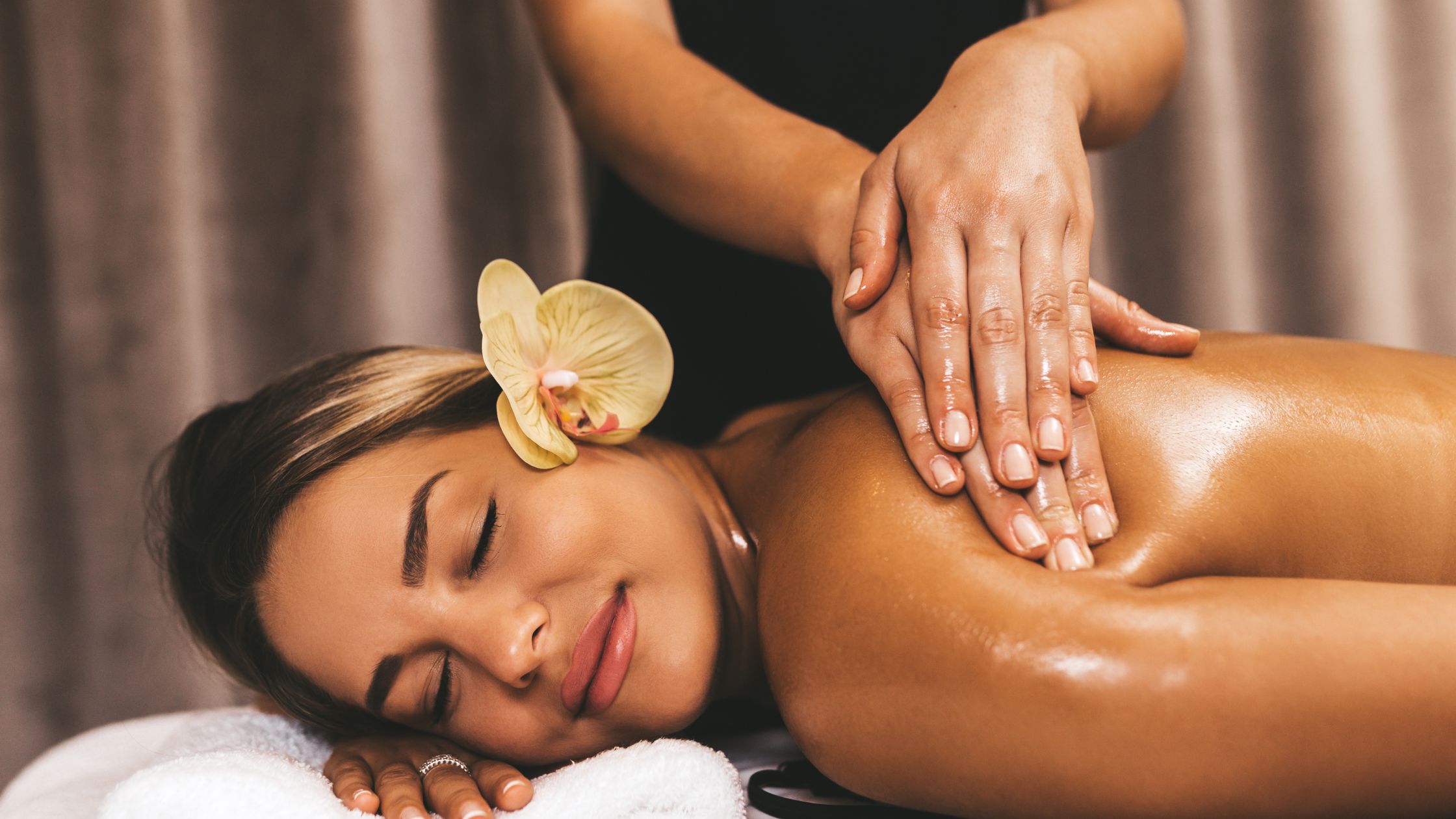 Relaxed woman enjoying Lomi Ke Ala Hoku massage, promoting stress relief and overall wellness.