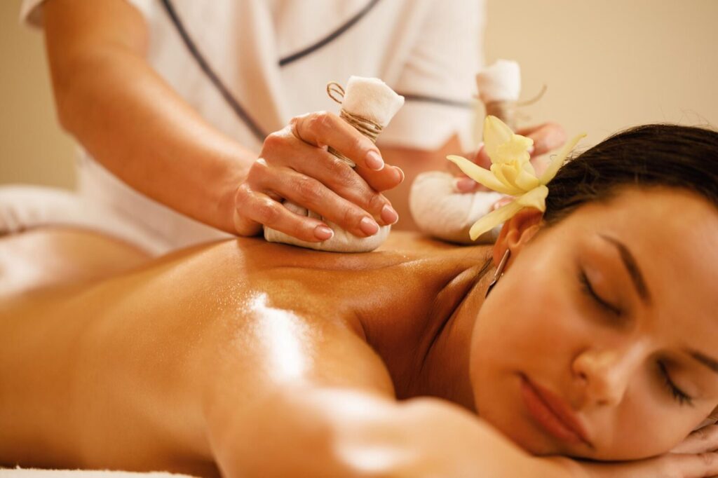 Client receiving an herbal poultice treatment, a possible heat application in Lomi Ke Ala Hoku massage.