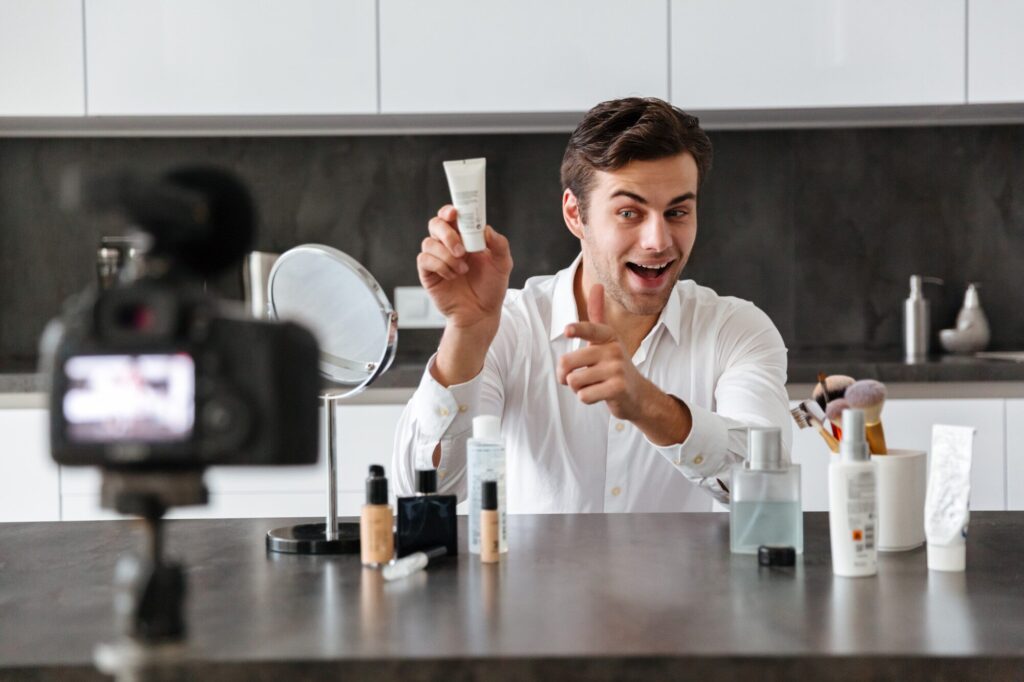 Beauty Kliniek client demonstrates the application of an advanced face cream for a complete men's skincare regimen.